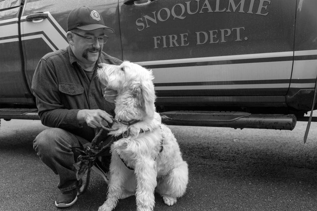 Lieutenant Jake Fouts takes therapy dog Phoebe out for a morning game of fetch. Ashley Hiruko/staff photo.