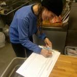 Snoqualmie resident Caitlin Ramirez signs the first signature on the petition on launch day. Courtesy Photo