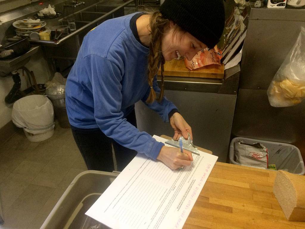 Snoqualmie resident Caitlin Ramirez signs the first signature on the petition on launch day. Courtesy Photo