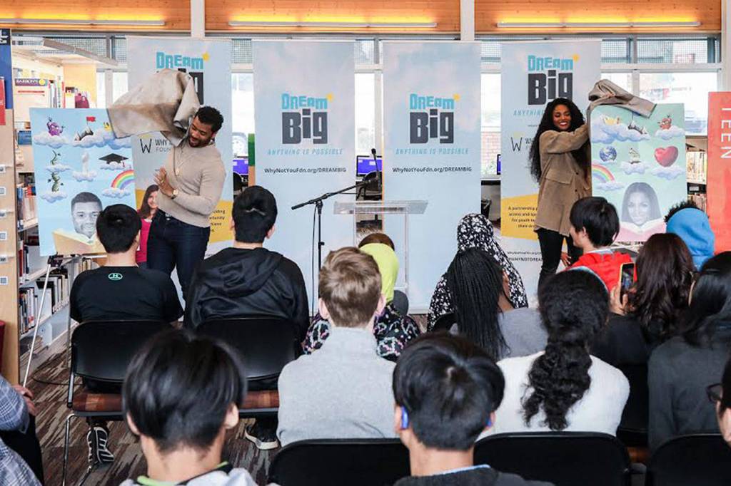Courtesy photo by Why Not You Foundation                                Russell Wilson and Ciara unveil the limited edition King County System Library cards that feature them and their dreams Friday at the Tukwila Library. The new library cards coincide with the newly launched DREAM BIG: Anything is Possible campaign.