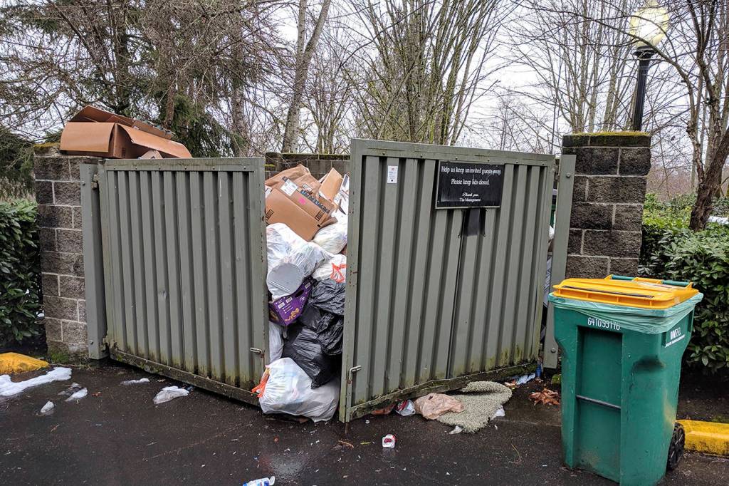 The trash situation at a Redmond apartment complex remained overflowing in the afternoon on Tuesday, Feb. 19, after a series of snowstorms hit the region in February. Corey Morris/staff photo