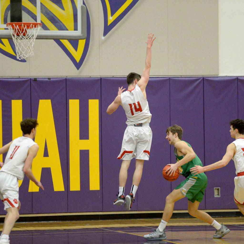 Mount Si Wildcats guard Brett Williams, (No. 14), scored a team-high 16 points against the Richland Bombers on Feb. 23. Mount Si defeated Richland 60-54. Photo courtesy of Calder Productions