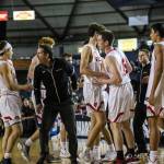 Mount Si Wildcats head coach Jason Griffith, center, displays his emotions while congratulating freshman point guard Bennett OConnor, left, for making clutch plays against the Puyallup Vikings. OConnor knocked down two free throws with 2.6 seconds left in regulation, sealing Mount Sis 45-40 victory against Puyallup in the Class 4A state quarterfinals. Photo courtesy of Don Borin/Stop Action Photography