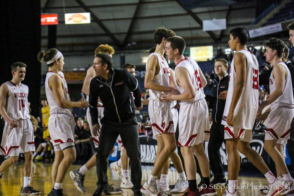 Mount Si Wildcats head coach Jason Griffith, center, displays his emotions while congratulating freshman point guard Bennett OConnor, left, for making clutch plays against the Puyallup Vikings. OConnor knocked down two free throws with 2.6 seconds left in regulation, sealing Mount Sis 45-40 victory against Puyallup in the Class 4A state quarterfinals. Photo courtesy of Don Borin/Stop Action Photography