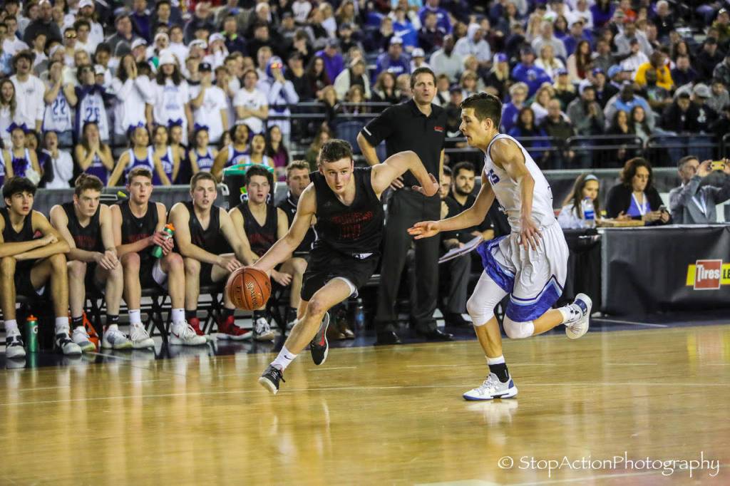 Mount Si Wildcats senior guard Brett Williams, left, drives to the basket against the Curtis Vikings in the Class 4A state semifinals on March 1. Williams scored 10 points in the contest. Photo courtesy of Don Borin/Stop Action Photography