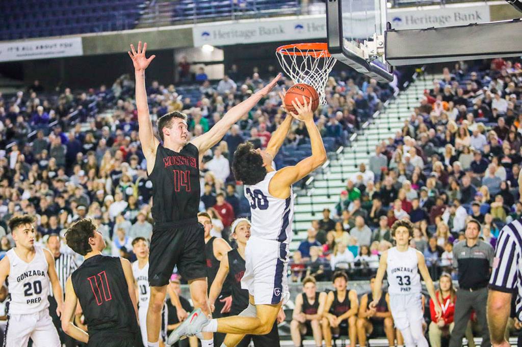 Mount Si Wildcats senior Brett Williams, center, tries to block Gonzaga Preps Sheadon Byrd on a drive to the basket in the Class 4A state championship game on March 2 at the Tacoma Dome. Gonzaga Prep defeated Mount Si 69-43. Photo courtesy of Don Borin/Stop Action Photography