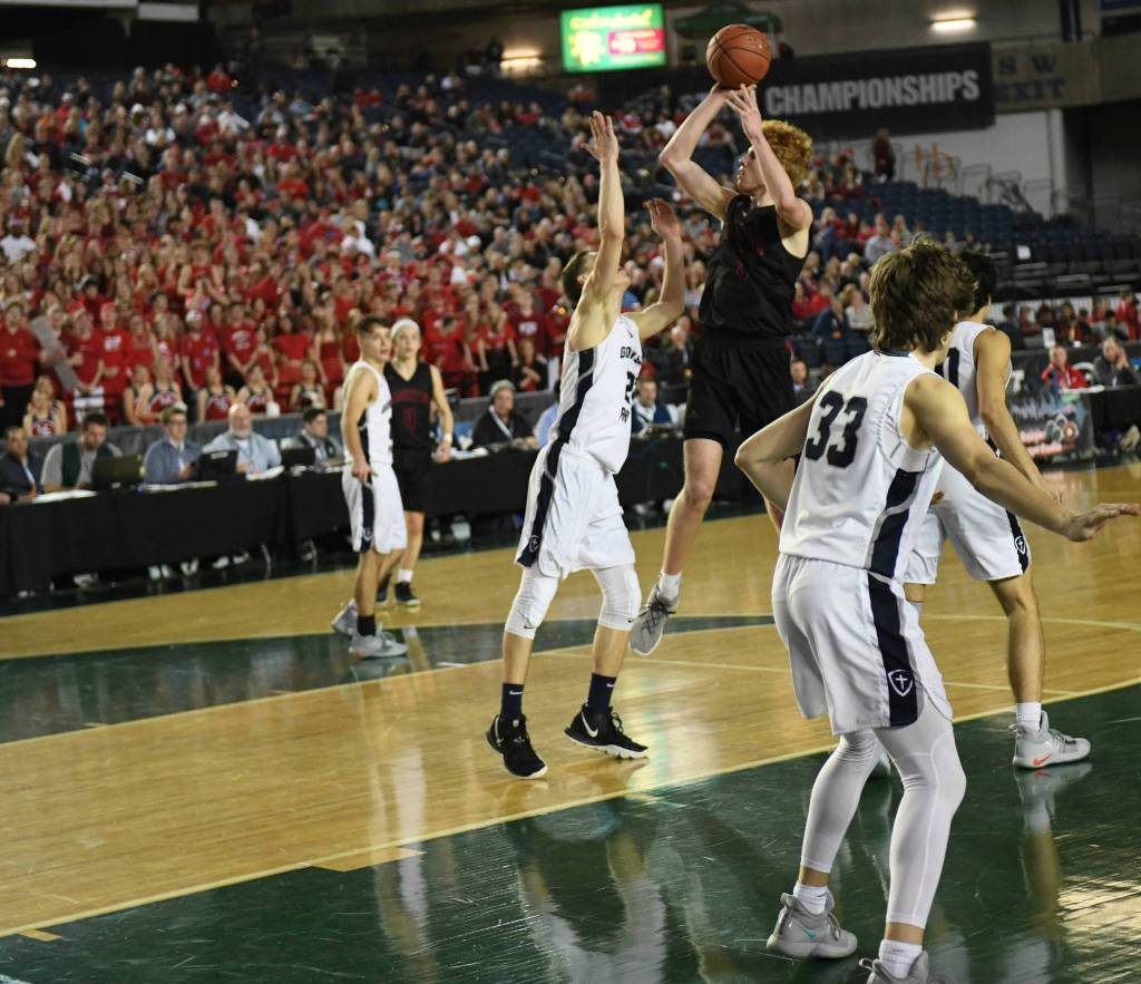 Mount Sis Jabe Mullins unleashes a shot at the 4A state tournament with the Wildcat sea-of-red crowd to his side. He is the 4A KingCo most valuable player. Courtesy of Calder Productions