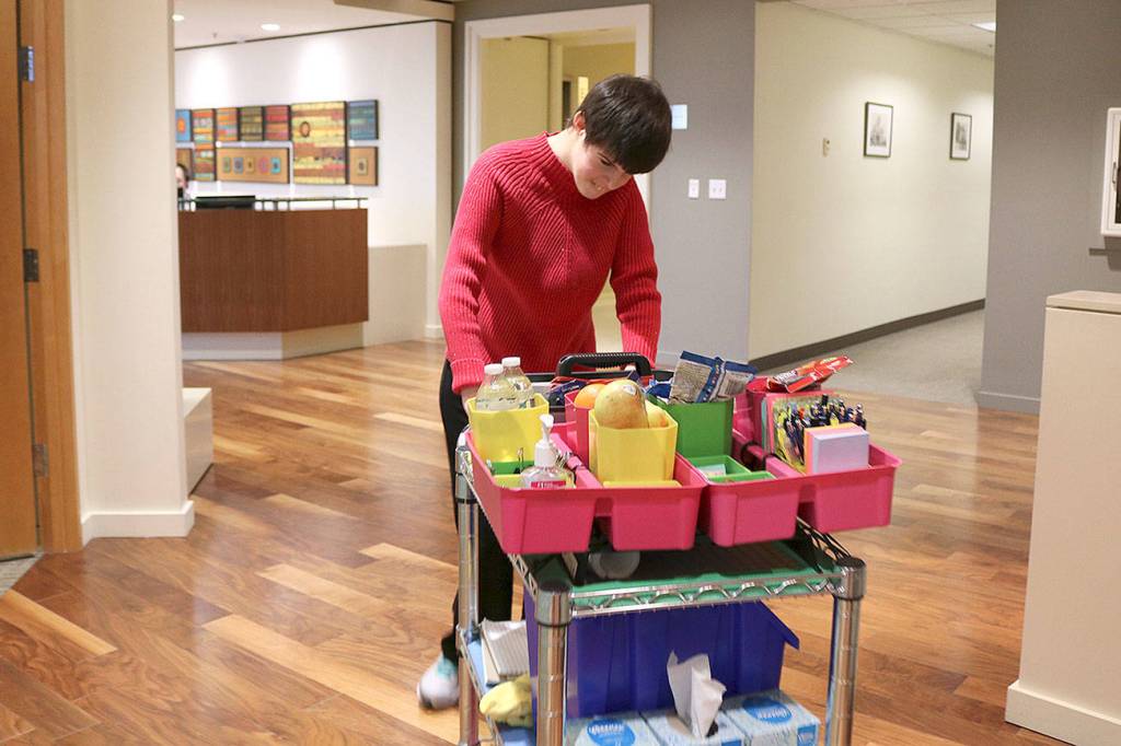 Paige Bisbee, of Bellevue is a paid employee at Davis Wright Tremaine in Bellevue. As part of the law firms inclusive program, Bisbee distributes snacks and office supplies to her co-workers. Stephanie Quiroz/staff photo.