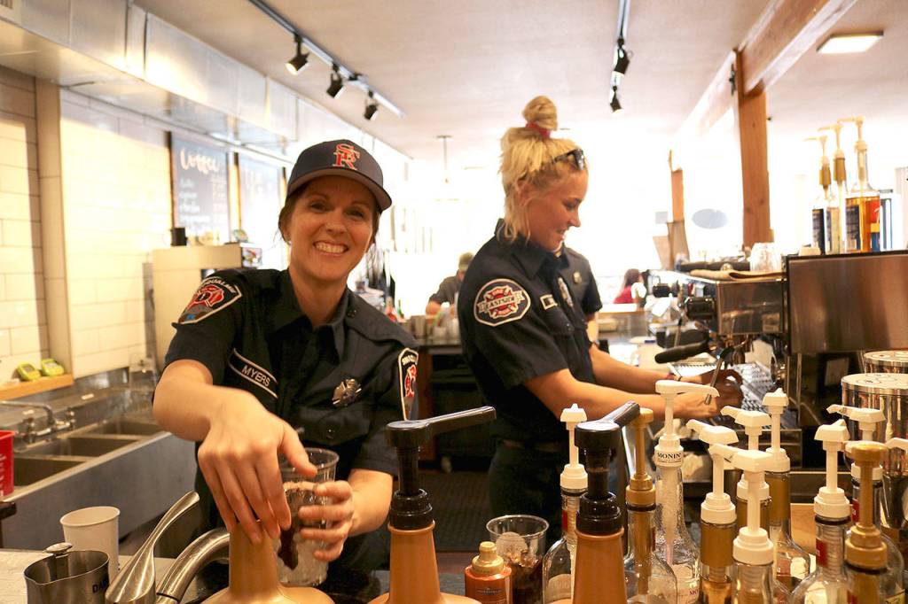Snoqualmie volunteer firefighter Kristina Myers made drinks at the Boots vs. Badges brew off event on March 19. Stephanie Quiroz/staff photo