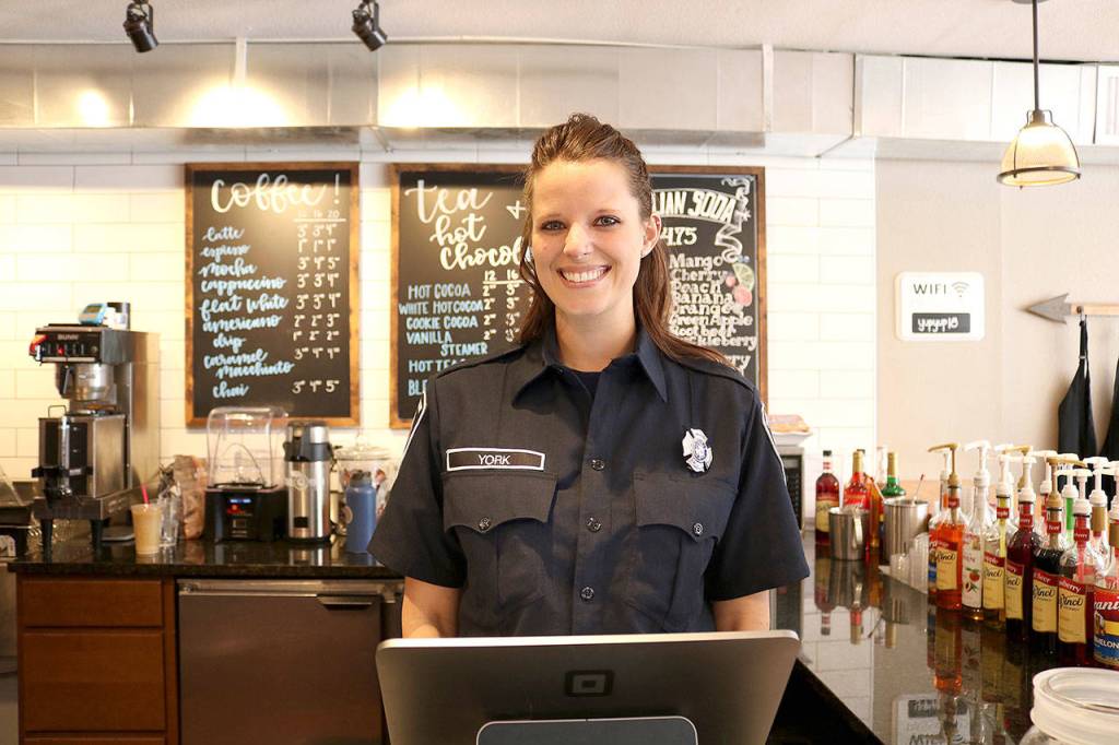 Snoqualmie firefighter Sara York took orders at Boots vs. Badges brew off event on March 19. Stephanie Quiroz/staff photo