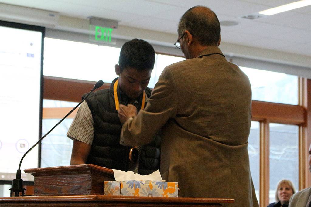 Chirag Vedullapalli receives a bronze medallion for his nonprofit work by Abraham Mathan of Prudential Financial. Madison Miller / staff photo