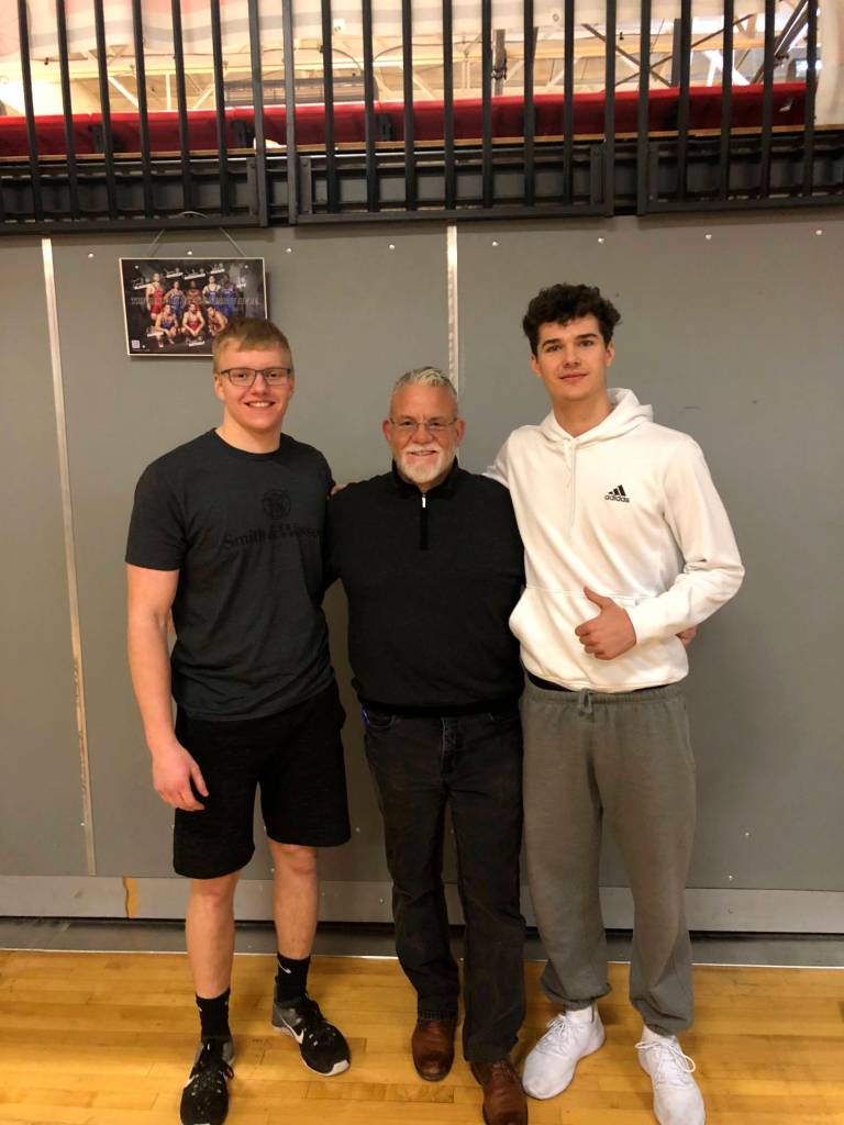 Mount Si lineman Cody Frederick, left, and Mount Si wide receiver Jonny Barrett, right, pose for a photo with Wildcats head coach Charlie Kinnune. Photo courtesy of Charlie Kinnune