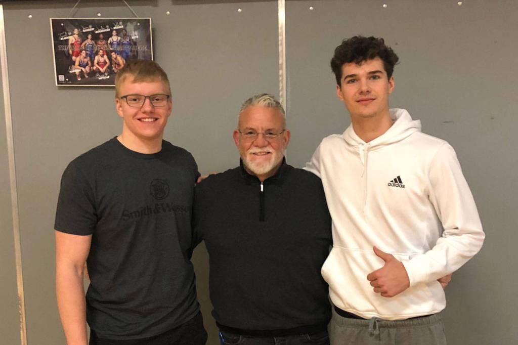 Mount Si lineman Cody Frederick, left, and Mount Si wide receiver Jonny Barrett, right, pose for a photo with Wildcats head coach Charlie Kinnune. Photo courtesy of Charlie Kinnune