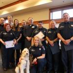 Volunteer Emergency Medical Service and Firefighters were recognized for their contribution to the city on April 10. From left, back row: Justin Venezia, Catherine Cotton, Mayor Matt Larson, Sara York, Tyson Adams, Thomas Walker, Paul Marrero, Robert Angrisano, Greg Prothman. Front row: Volunteer EMS Lorrie Jones, with Phoebe the Dog. Evan Pappas/Staff Photo