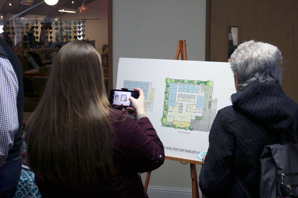 Community members join local government leaders, church officials and workers at the Salt House Church in Kirkland to celebrate the shelter groundbreaking. Locals were able to see designs for the shelter and ask questions of staff. Kailan Manandic/staff photo
