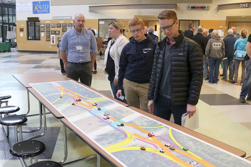 David Mills of North Bend, right, examines the map layout of the new diverging diamond design proposed for the I-90 and SR 18 interchange. Evan Pappas/Staff Photo