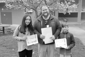 Courtesy photo                                David Hamilton of North Bend, center, presents checks to Kiwanis Kindness Essay contest winners Selena Huante, left, and Bentley Moore, both of North Bend Elementary. Other contest winners are Rebekah Baker and Kenahdie Wilkins, both of Fall City, Ellen Callahan and Claire Tougher, both of Cascade View, Lauren Blad of Timber Ridge, Hannah LaCroix of Parent Partnership, Asher Shuck of Snoqualmie Elementary, and Katie Holloway, Zachary Graham and Josef Treiber, all of Opstad.