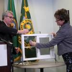 Dr. Brian Johnston, Chief of Pediatrics at Harborview Medical Center, and Councilmember Kathy Lamber give a demonstration with a window safety device. Ashley Hiruko/staff photo