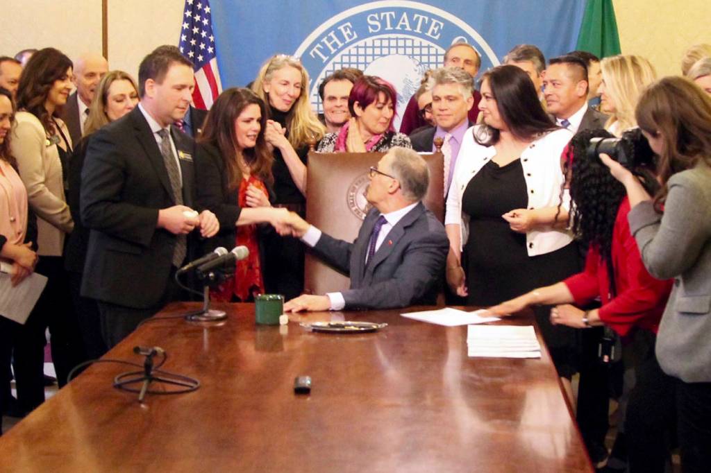 Gov. Jay Inslee shakes hands with Dinah Griffey after signing Senate Bill 5649 on April 19. The law revises the statute of limitations for sex crimes. Photo by Emma Epperly, WNPA Olympia News Bureau