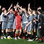 The Mount Si Wildcats boys soccer team hoists the 4A KingCo championship trophy following their victory against the Issaquah Eagles on April 30. Photo courtesy of Calder Productions