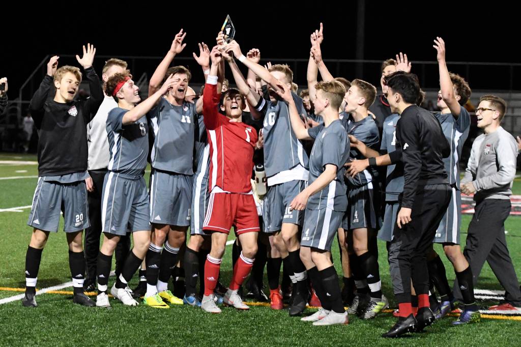 The Mount Si Wildcats boys soccer team hoists the 4A KingCo championship trophy following their victory against the Issaquah Eagles on April 30. Photo courtesy of Calder Productions