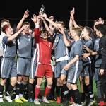 The Mount Si Wildcats boys soccer team hoists the 4A KingCo championship trophy following their victory against the Issaquah Eagles on April 30. Photo courtesy of Calder Productions