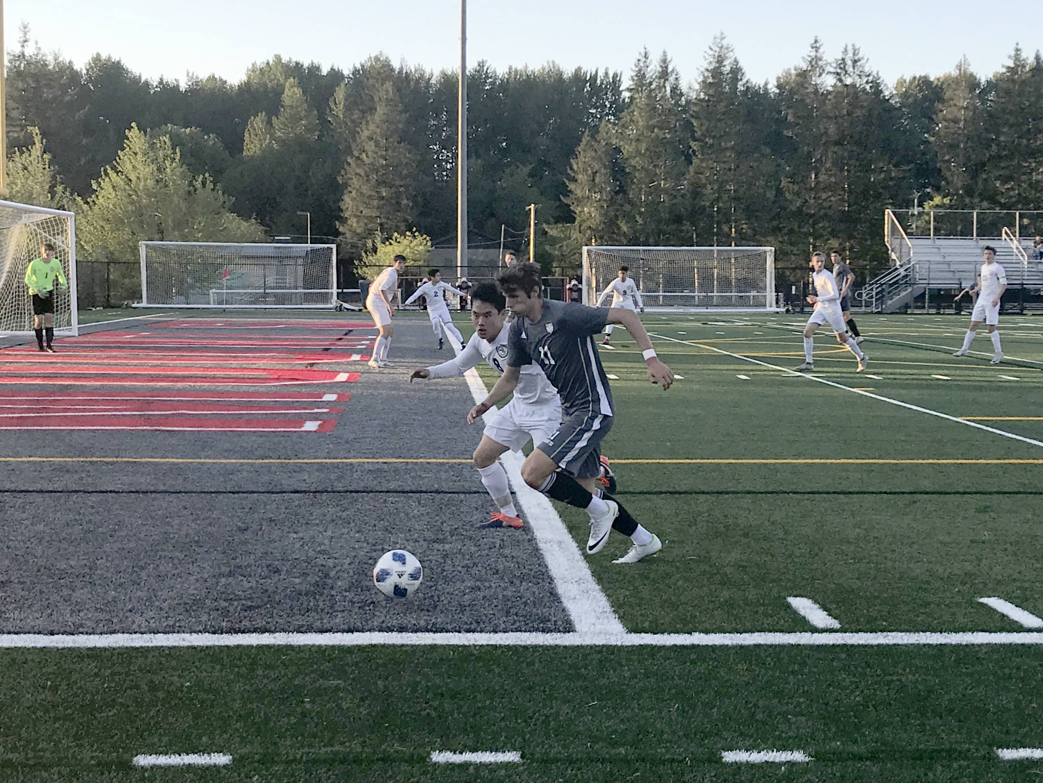 Mount Si Wildcats senior Drew Harris chases the ball while being defended by Jacksons Minhyok Kim in the first half of play. Jackson defeated Mount Si in an overtime penalty kick shootout (6-5) en route to a 3-2 victory in the Wes-King 4A boys district soccer tournament championship game on May 9 at Mount Si High School in Snoqualmie. Shaun Scott/staff photo