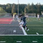 Mount Si Wildcats senior Drew Harris chases the ball while being defended by Jacksons Minhyok Kim in the first half of play. Jackson defeated Mount Si in an overtime penalty kick shootout (6-5) en route to a 3-2 victory in the Wes-King 4A boys district soccer tournament championship game on May 9 at Mount Si High School in Snoqualmie. Shaun Scott/staff photo