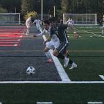 Mount Si Wildcats senior Drew Harris chases the ball while being defended by Jacksons Minhyok Kim in the first half of play. Jackson defeated Mount Si in an overtime penalty kick shootout (6-5) en route to a 3-2 victory in the Wes-King 4A boys district soccer tournament championship game on May 9 at Mount Si High School in Snoqualmie. Shaun Scott/staff photo