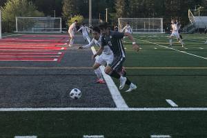 Mount Si Wildcats senior Drew Harris chases the ball while being defended by Jacksons Minhyok Kim in the first half of play. Jackson defeated Mount Si in an overtime penalty kick shootout (6-5) en route to a 3-2 victory in the Wes-King 4A boys district soccer tournament championship game on May 9 at Mount Si High School in Snoqualmie. Shaun Scott/staff photo
