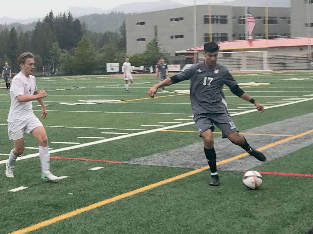 Mount Si junior defender Jake Jimenez, right, passes the ball up field to a teammate in the first half of play against the Sumner Spartans. Mount Si defeated Sumner 2-1 in the first round of the 4A state playoffs on May 15 at Mount Si High School in Snoqualmie. Shaun Scott/staff photo