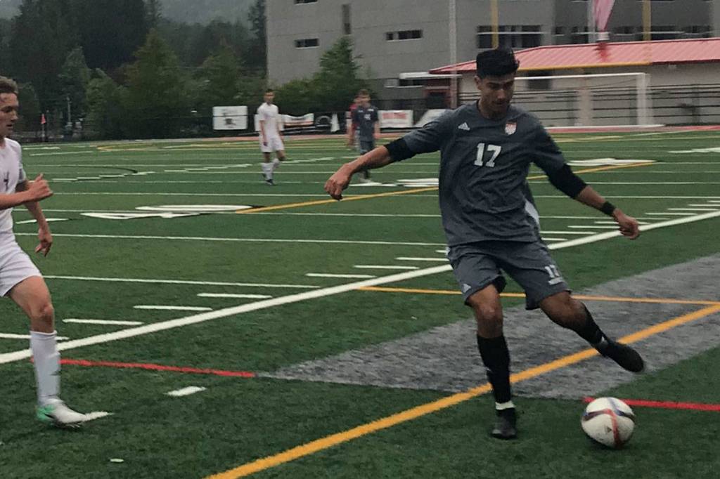 Mount Si junior defender Jake Jimenez, right, passes the ball up field to a teammate in the first half of play against the Sumner Spartans. Mount Si defeated Sumner 2-1 in the first round of the 4A state playoffs on May 15 at Mount Si High School in Snoqualmie. Shaun Scott/staff photo