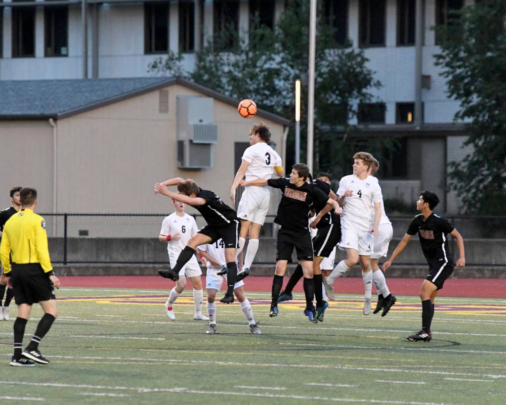 Mount Si senior defender Reed Paradissis (No. 3) leaps high into the air to clear the ball with a header against Issaquah. Paradissis scored two goals (16th minute, 51st minute) in the contest. Photo courtesy of Calder Productions