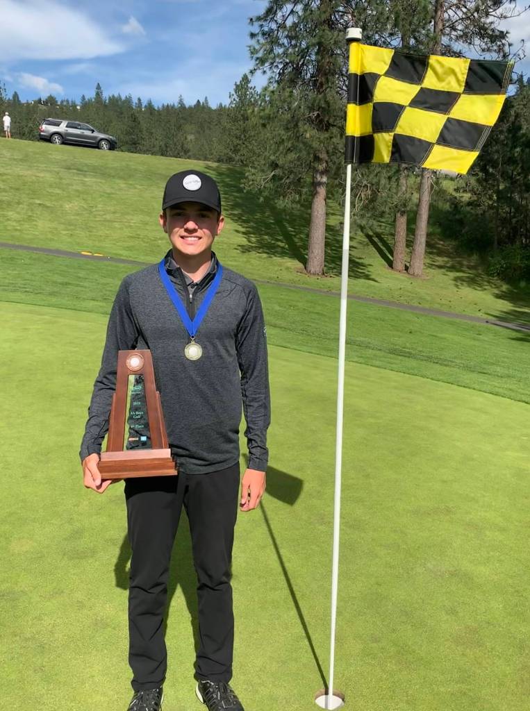 Mount Sis Drew Warford sports his first-place medal and holds the teams fourth-place trophy at The Creek at Qualchan Golf Course in Spokane. Courtesy photo