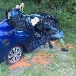 Three people, traveling in the pictured blue car, were injured after being struck by a car fleeing police. Photo courtesy of Washington State Patrol