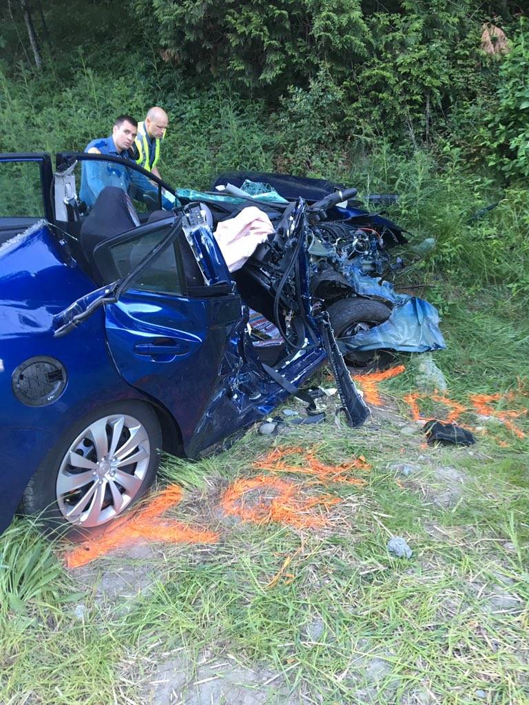 Three people, traveling in the pictured blue car, were injured after being struck by a car fleeing police. Photo courtesy of Washington State Patrol