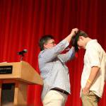 Marcella Murphy gives senior Joe Harris the first AVID medallion that all the AVID seniors will wear at graduation from this year forward. Madison Miller / staff photo