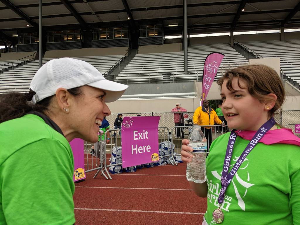 A coach and a runner chat at the Girls on the Run 5K event. Courtesy photo