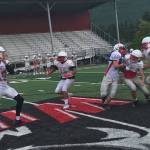 Mount Si Wildcats junior quarterback Clay Millen, left, drops back in the pocket before delivering a pin-point pass during a spring practice session on June 6 at Mount Si High School in Snoqualmie. Shaun Scott/staff photo