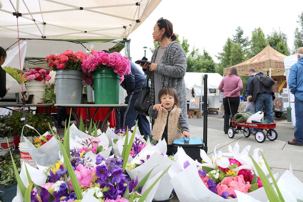 Emi Baba and Aj Baba, 2 of North Bend at the farmers market opening day on June 6. Stephanie Quiroz/staff photo