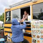 Stephanie Quiroz / staff photos                                Customers buy food from the food trucks at the North Bend Farmers Market opening day on June 6.