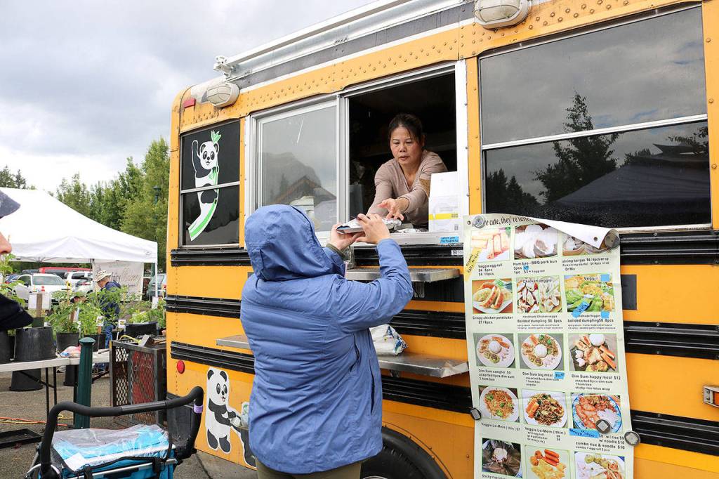 Stephanie Quiroz / staff photos                                Customers buy food from the food trucks at the North Bend Farmers Market opening day on June 6.