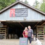 The 1924 train shed roof sits on the property as North Bend Art and Industry raises the money to rebuild the careful deconstructed and catalogued building. Debra Landers, left, and Beth Burrows prepared for the Summer kick off event with Landers dog Freyja on Saturday. Evan Pappas/Staff Photo