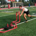 Mount Si Wildcats running back Cole Norah pushes a sled during the Wildcats speed and agility camp on July 23 at Mount Si High School in Snoqualmie. Shaun Scott/staff photo