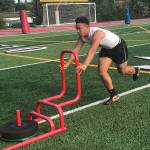 Mount Si Wildcats running back Cole Norah pushes a sled during the Wildcats speed and agility camp on July 23 at Mount Si High School in Snoqualmie. Shaun Scott/staff photo
