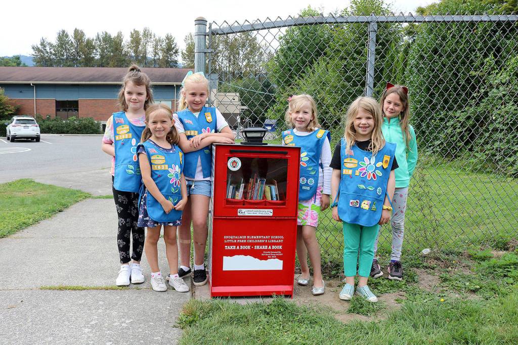 Photo by Stephanie Quiroz/staff photo                                Girl Scout Troop 41637 raised funds to install a Little Free Childrens Library outside of Snoqualmie Elementary School.