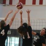 Mount Si volleyball players attack the net during practice on Sept. 5 in their new gym. Emily Dann, Dana Dolan and Megan Underbrink are pictured. Andy Nystrom/ staff photo