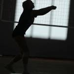 In this shot from Mount Sis Sept. 5 practice, the sun shines into the gym and generates an artistic photo. Andy Nystrom/ staff photo