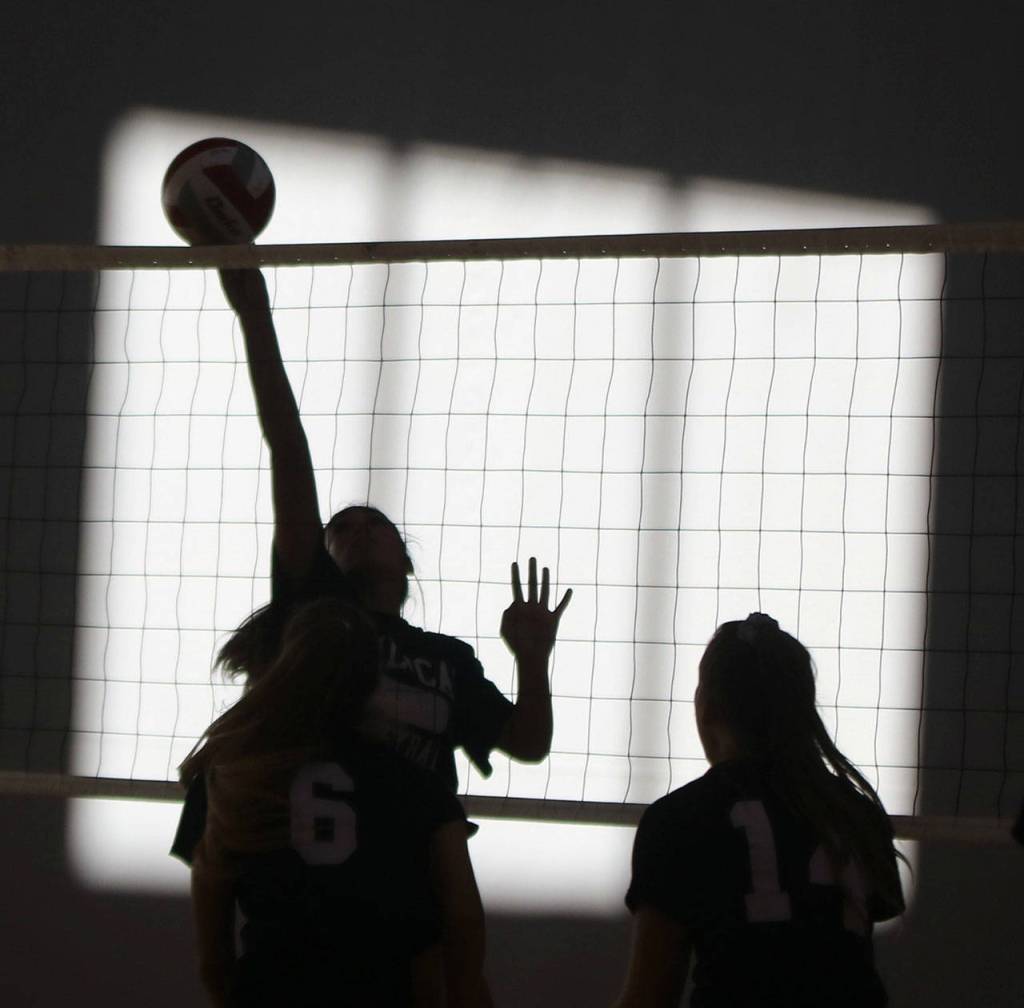 Another artistic shot displays strong net play during practice. Andy Nystrom/ staff photo