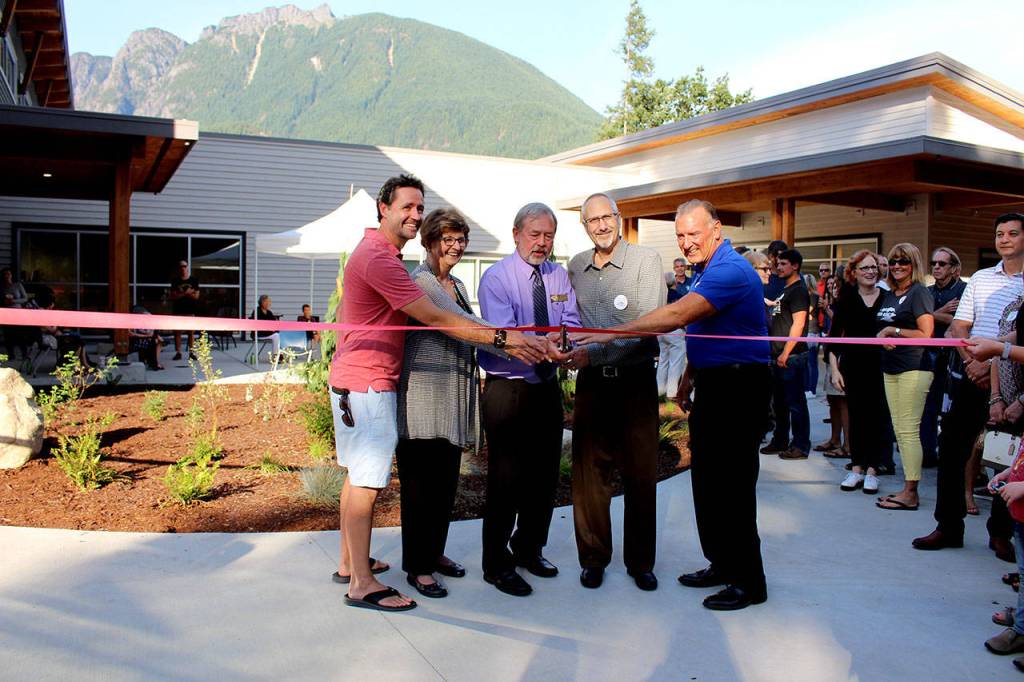 Photo by Natalie DeFord                                Brenden Elwood, Jeanne Pettersen, Mayor Ken Hearing, Alan Gothelf and Ross Loudenback perform the ribbon cutting at a special ceremony at North Bends new City Hall Sept. 5.